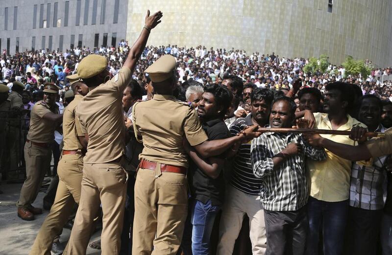 Police officials try to contain supporters of Jayalalithaa Jayaram outside Chennai's Rajaji Hall where her body lay in state on December 6, 2016. Aijaz Rahi/AP Photo