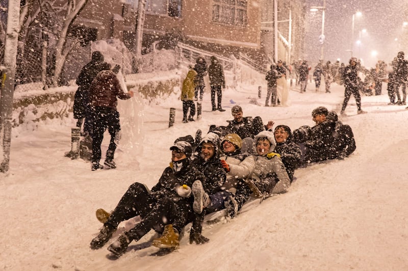Children slide on the snow at the Kucukcekmece district in Istanbul. AFP