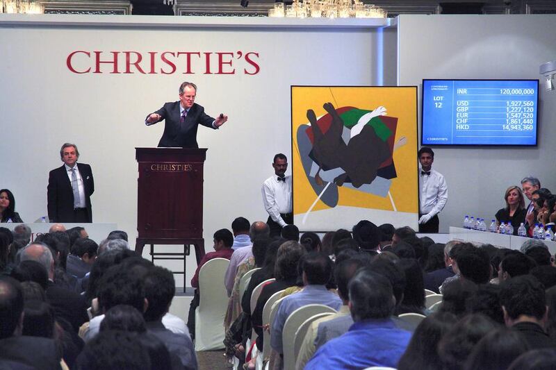Bidding for artist Tyeb Mehta's untitled canvas depicting a falling bull sold for 150 million rupees at a Christie’s auction. Subhash Sharma for The National