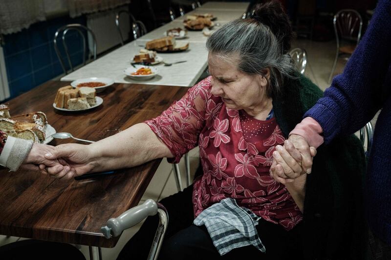 An elderly refugee from Avdiivka, eastern Ukraine, at a lunch provided by church group Awakening in Pokrovsk. AFP