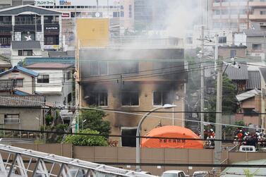 This picture shows a general view of smoke still coming from an animation company building after a fire in Kyoto on July 18, 2019. AFP