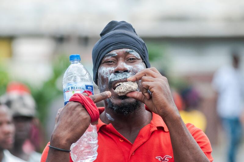 A man points to a stone during a protest in Port-au-Prince. EPA