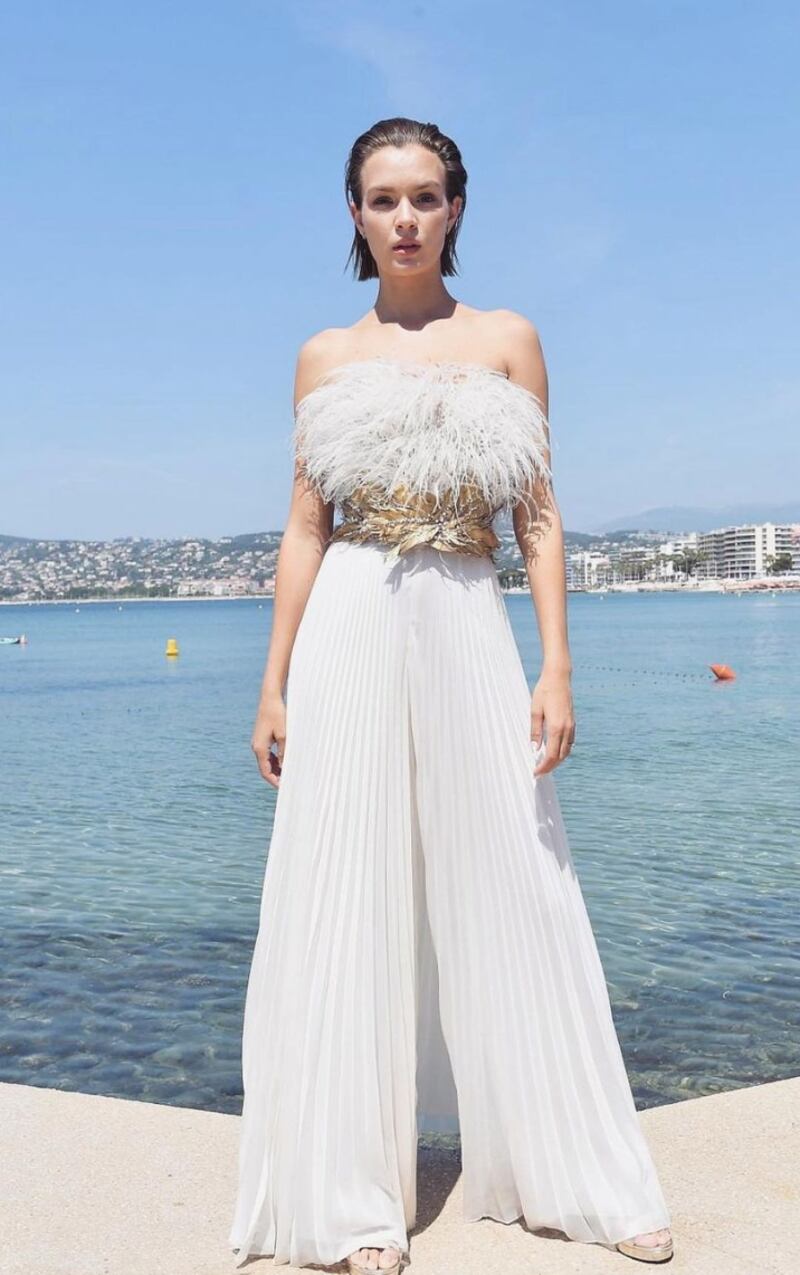 Josephine Skriver is elegance personified in a couture autumn–winter 2021 look, an all-white, strapless top with plisse trousers, topped with feathers. Photo: Rami Al Ali