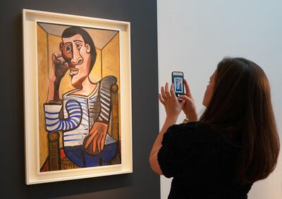A Christie's employee takes a picture of Pablo Picasso's Le Marin during a media preview at Christie's May 3, 2018 in New York.                                / AFP PHOTO / Don EMMERT