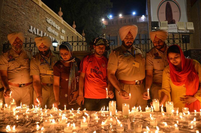 Indian Punjab Police personnel light candles along with local residents as they pay tribute to the Jallianwala Bagh massacre martyrs on the eve of the 100th anniversary of the Jallianwala Bagh massacre, in Amritsar on April 12, 2019. The Amritsar massacre, 100 years ago this April 13 in which British troops opened fire on thousands of unarmed protestors, remains one of the darkest hours of British colonial rule in India. Known in India as the Jallianwala Bagh massacre, it is still an emotive subject with many demanding a British apology -- which so far has been unforthcoming.
 - TO GO WITH: India-colonialism-diplomacy-Britain, CHRONO 
 / AFP / NARINDER NANU / TO GO WITH: India-colonialism-diplomacy-Britain, CHRONO 
