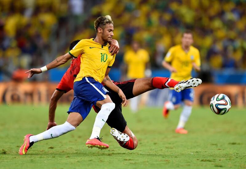 Neymar of Brazil is challenged by Francisco Javier Rodriguez of Mexico during their match on Tuesday at the 2014 World Cup. Buda Mendes / Getty Images