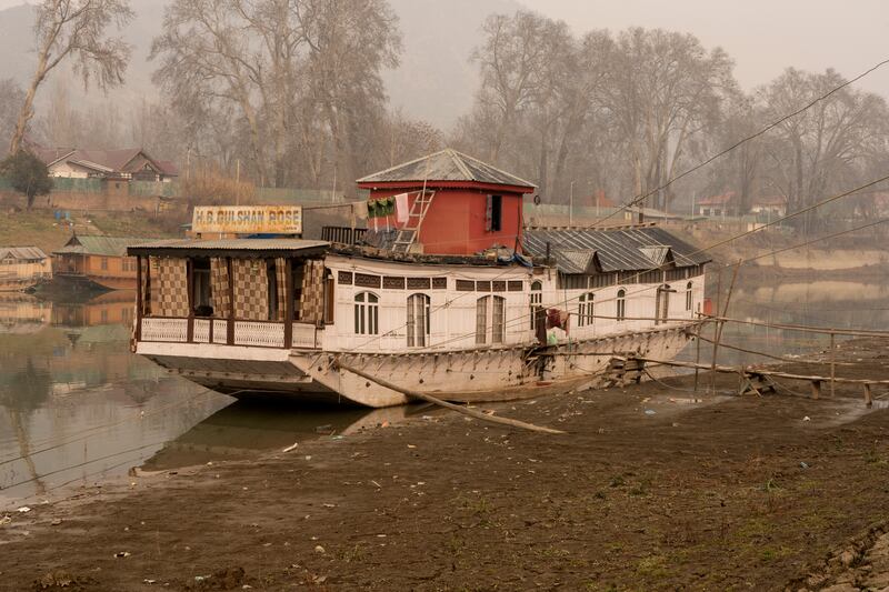 A houseboat in River Jhelum, Srinagar, sits low because of depleted water levels. Wasim Nabi for The National