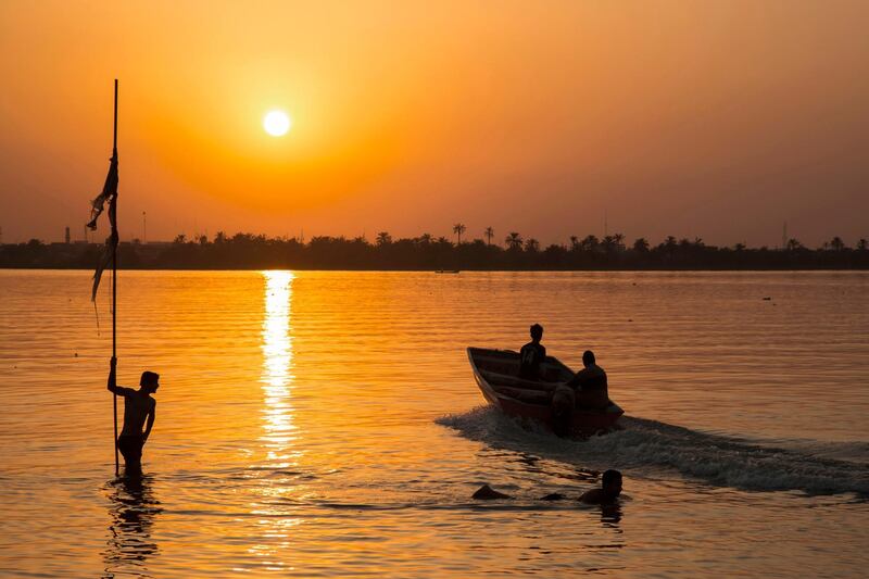 Iraqi men swim in the Shatt al-Arab river in the southern port of Basra.  AFP