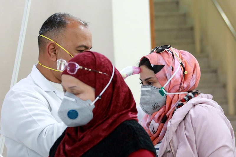 Members of Iraqi medical team check passengers upon arrival from Iran at Baghdad international airport in Baghdad, Iraq.  EPA