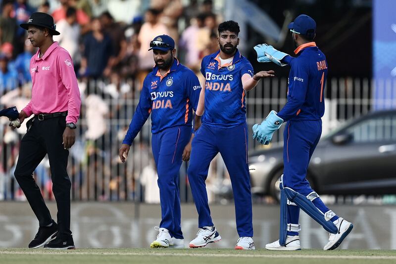 India's Mohammed Siraj, centre, celebrates with teammates after the dismissal of Australia batter Ashton Agar for 17. AFP