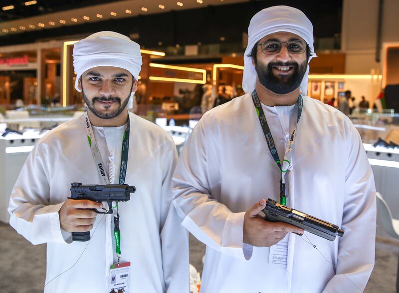 Saoud and brother Salem Al Shamsi check out the firepower at the exhibition. Victor Besa / The National