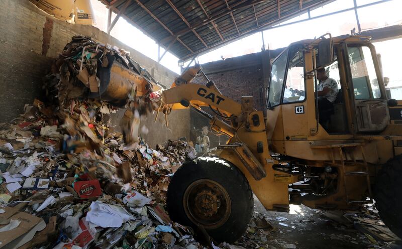 A man picks up waste cardboard for recycling to be re-sold in Mokattem. 