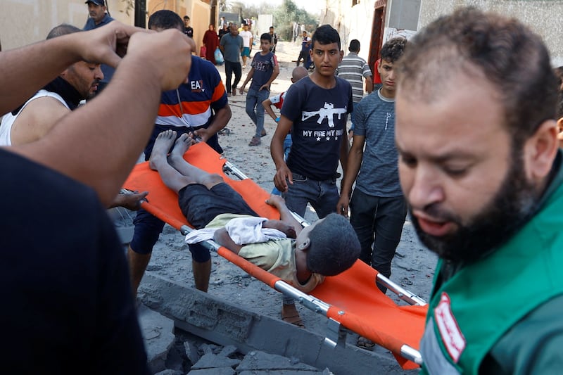 A wounded boy is rescued from the rubble after Israeli air strikes, in Khan Younis. Reuters