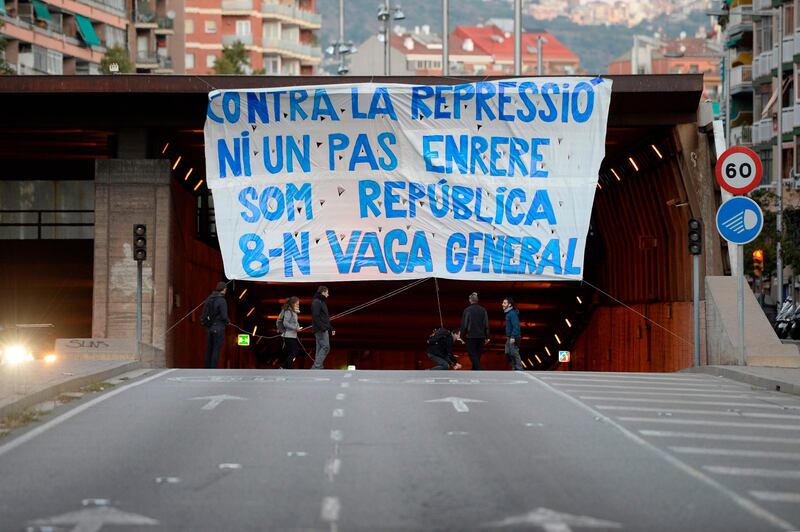 General strikers in Barcelona unfurl a giant banner reading "Not a step back against repression. We are the republic. General strike".   Josep Lago / AFP Photo