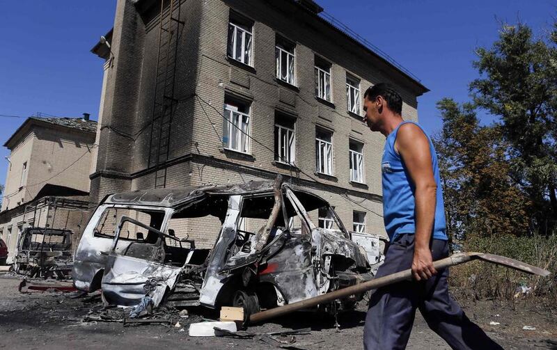 A man walks past vehicles destroyed during the recent shelling in the eastern Ukrainian town of Ilovaysk. The West has not understood Russia's fears of NATO's expansion, writes Tony Karon (REUTERS/Maxim Shemetov)