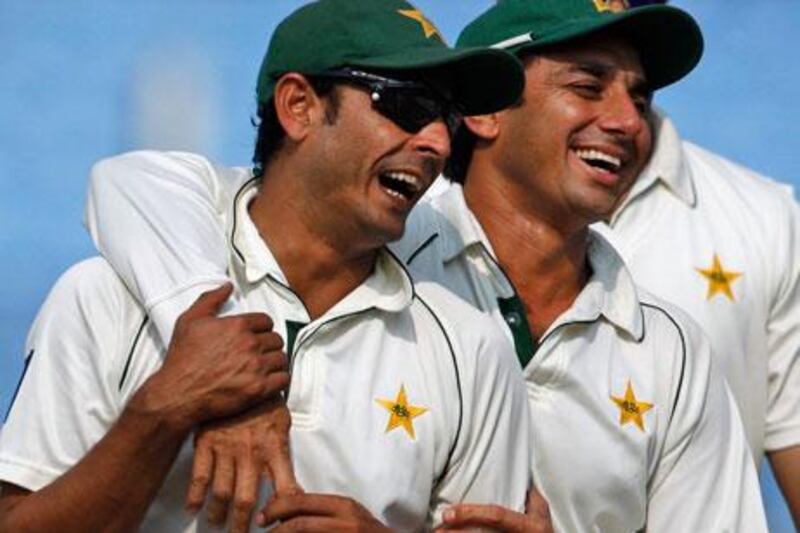 Pakistan's Abdur Rehman, left, and Saeed Ajmal celebrate after beating Bangladesh by an innings and 184 runs on the fourth day of the first Test.