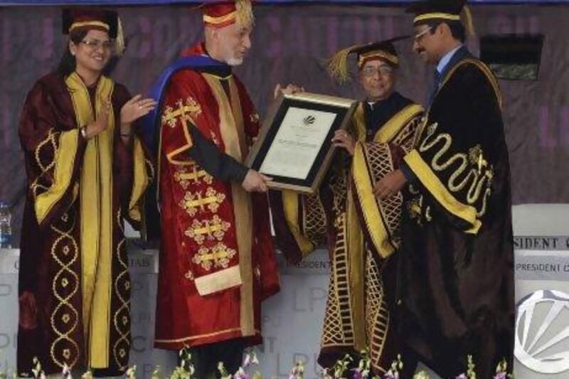 Afghanistan's president Hamid Karzai (second from left) receives an honourary degree from his Indian counterpart Pranab Mukherjee at the Lovely Professional University on the outskirts of the northern Indian city of Jalandhar.