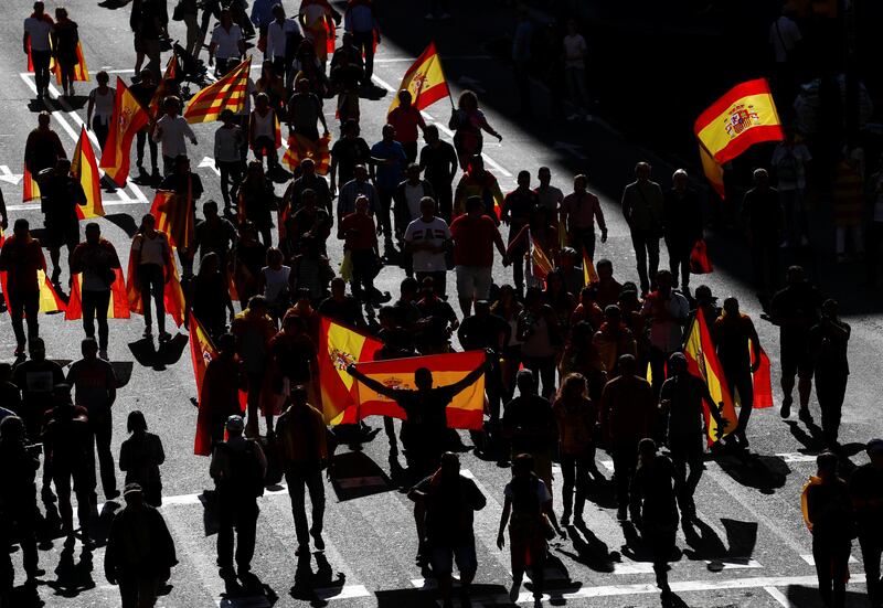 People carry Catalan and Spanish flags as demonstrators gathered for a pro-union demonstration organised by the Catalan Civil Society organisation in Barcelona, Spain. Juan Medina / Reuters