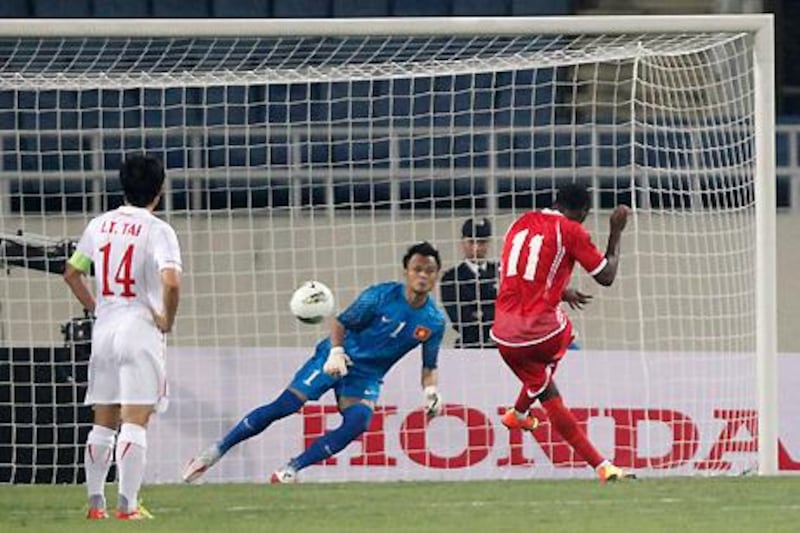 Ahmed Khalil fires home the UAE's penalty to open the scoring against Vietnam in their Asian Cup qualifying match.