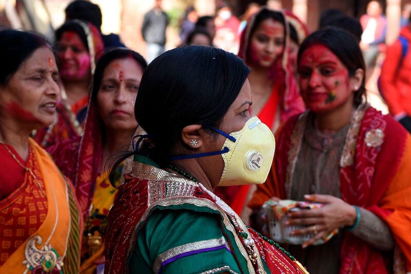 A reveller wearing a facemask amid fears of the spread of COVID-19 novel coronavirus, arrives to celebrate Holi, the spring festival of colours, in Kathmandu on March 9, 2020. Holi is observed at the end of the winter season on the last full moon of the lunar month. AFP