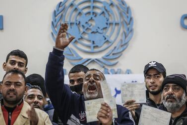 A man holding a refugee card shouts slogans as other demonstrators gather around him during a protest calling on the United Nations Relief and Works Agency (UNRWA) to pay Palestinians for the repair of their homes, damaged during the 2014 Israel Gaza conflict. AFP