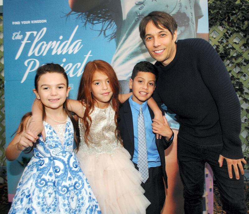 MAITLAND, FL - OCTOBER 04:  (L-R) Cast members Brooklynn Prince, Valeria Cotto, Christopher Rivera and Director Sean Baker pose during "THE FLORIDA PROJECT" Cast & Crew Orlando Premiere at The Enzian Theater on October 4, 2017 in Maitland, Florida.  (Photo by Gerardo Mora/Getty Images for A24)