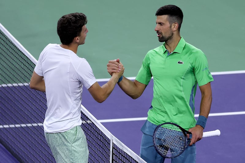 Novak Djokovic greets Luca Nardi at the net following their match in the Indian Wells second round. Getty Images