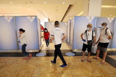 DUBAI, UNITED ARAB EMIRATES , April 29 – 2020 :- Shoppers wearing protective face mask to prevent the spread of the coronavirus at Mall of the Emirates in Dubai. Authorities ease the restriction for the residents in Dubai. At present mall opening timing is 12:00 pm to 10:00 pm. Carrefour timing is 9:00 am to 10:00 pm. Barricades put up around the food court area during the Ramadan. (Pawan Singh / The National) For News/Standalone/Online. Story by Patrick