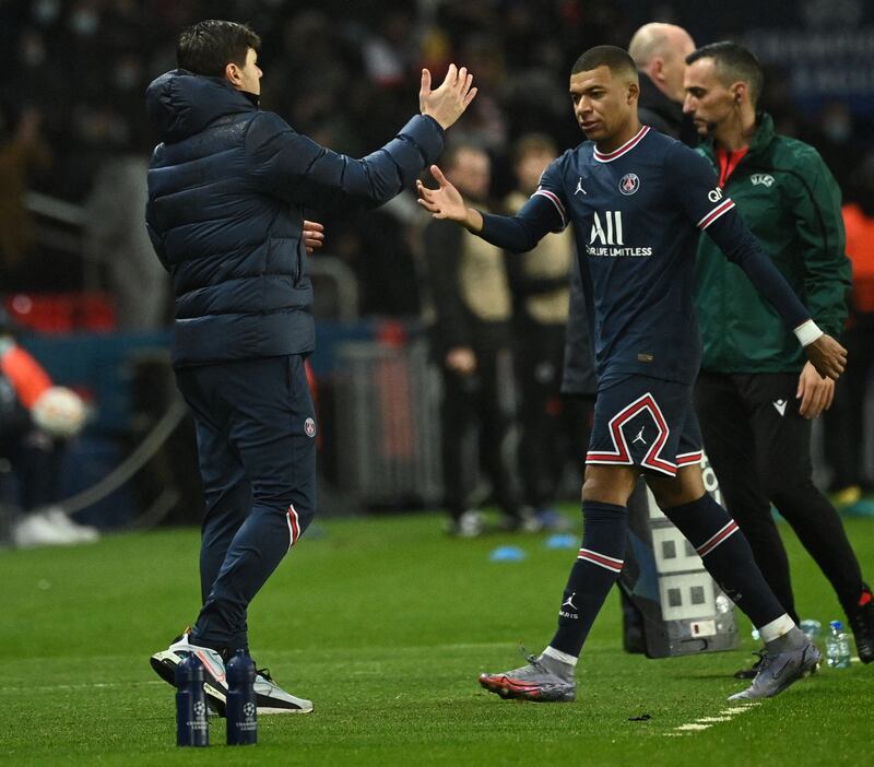 Kylian Mbappe shakes hands with Paris Saint-Germain coach Mauricio Pochettino. AFP