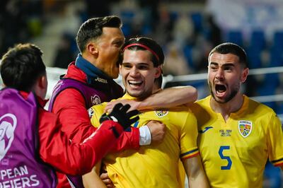 Romania's Ianis Hagi, centre, celebrates with teammates after scoring the winner against Israel. EPA