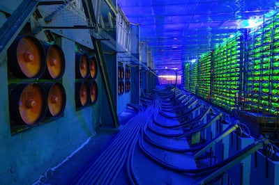 Industrial cooling fans operate to thermally regulate illuminated mining rigs at the CryptoUniverse cryptocurrency mining farm in Nadvoitsy, Russia, on Thursday, March 18, 2021. The rise of Bitcoin and other cryptocurrencies has prompted the greatest push yet among central banks to develop their own digital currencies. Photographer: Andrey Rudakov/Bloomberg