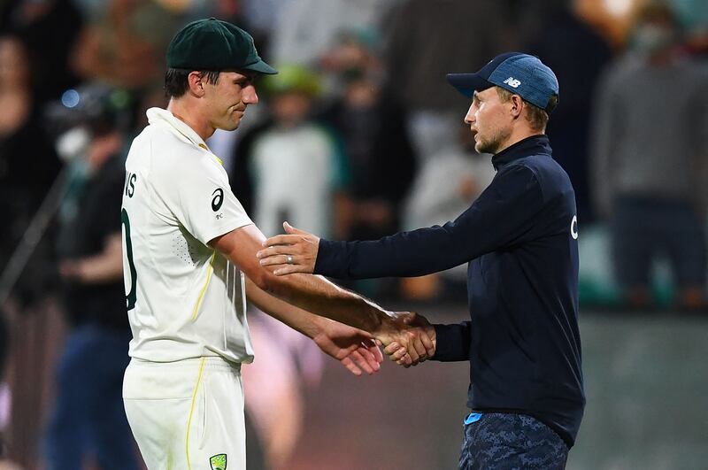 Australia captain Pat Cummins, left, shakes hands with England counterpart Joe Root after Australia won the fifth Ashes Test match in Hobart. AFP
