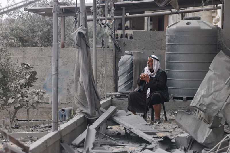 A man sits among the rubble of a building destroyed in Israel's bombardment of Rafah, in the southern Gaza Strip. AFP