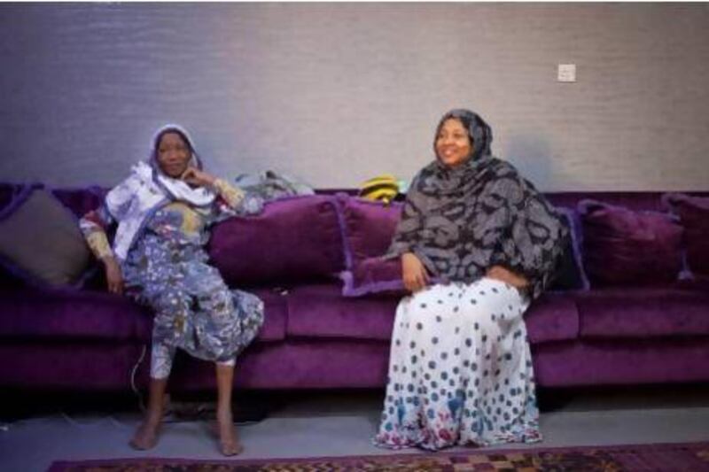 Halima Al Suwaidi (right) sits with her mother Amna Al Noubi in the living room of their home off Al Wasl Road. Amna remembers moving to the area 25 years ago when they were forced to leave their beach home in Jumeirah. Razan Alzayani / The National