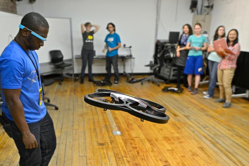 A programmer controls a drone toy drone using Google glasses. Kike Calvo via AP Images