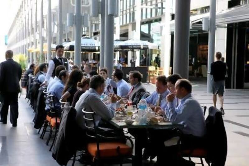 People having lunch at one of the restaurants in DIFC in Dubai. Fewer than a third of those who responded to a recent survey on work-life balance said their employer offered healthy snacks in the workplace cafeteria, compared with 42 per cent globally.