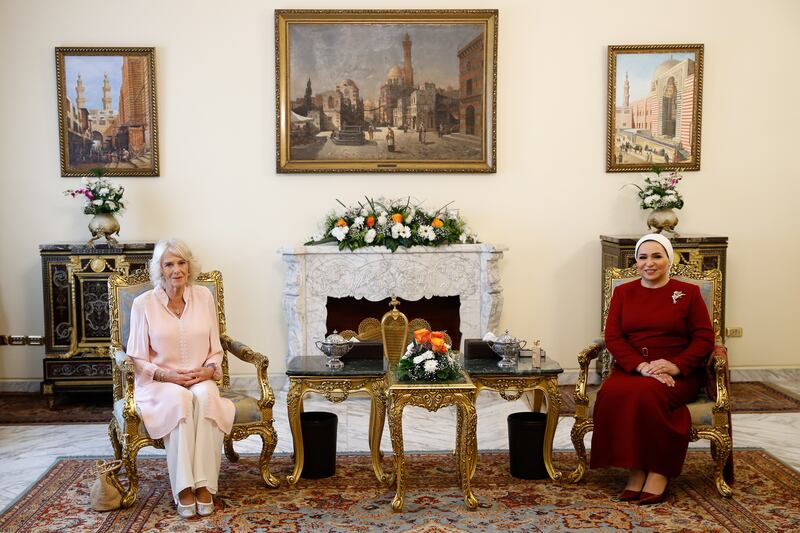 Camilla, left, is welcomed by Entissar Amer, the wife of Egyptian President Abdel Fattah El Sisi, at the presidential palace in Cairo.  Reuters