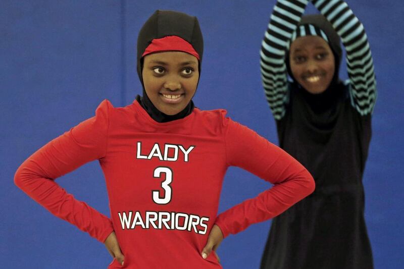 Zubeda Chaffe shown at a basketball practice in her new 'Lady Warriors' basketball uniform, which the girls of the team in Minnesota helped design. Jim Mone / AP
