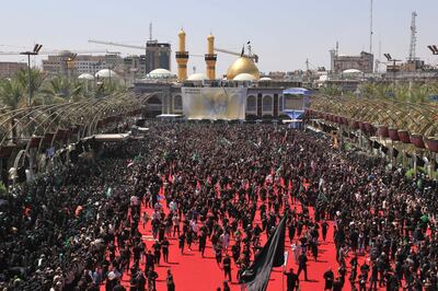 Iraqi Shiite Muslims take part in a mourning procession on the tenth day of the lunar month of Muharram which marks the day of Ashura, in the holy city of Karbala, on September 10, 2019.  The day of Ashura is commemorated by Shiite Muslims worldwide and marks the climax of mourning rituals in the Islamic month of Muharram for the 7th century killing of Imam Hussein, the grandson of Prophet Mohammed, in the Battle of Karbala in 680 AD.
 / AFP / Mohammed SAWAF

