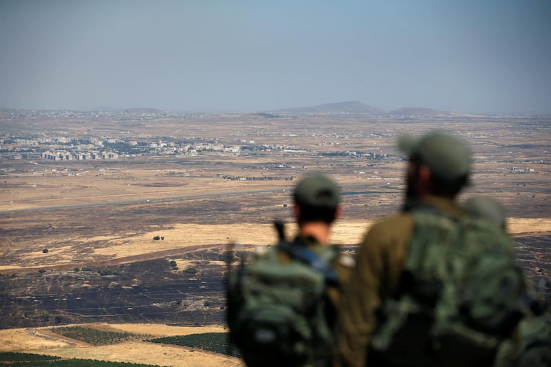 Israeli soldiers look at the Syrian side of the Israel-Syria border on the Israeli-occupied Golan Heights, Israel July 7, 2018. REUTERS/Ronen Zvulun