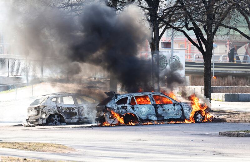 Cars are set ablaze in Norrkoping. AP