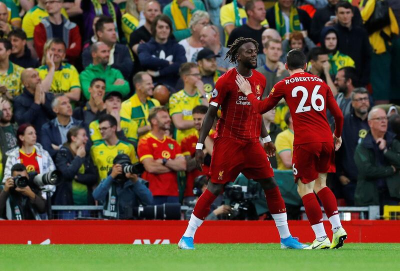 Andrew Robertson and Divock Origi celebrate their first goal scored by Norwich City's Grant Hanley with an own goal. Reuters