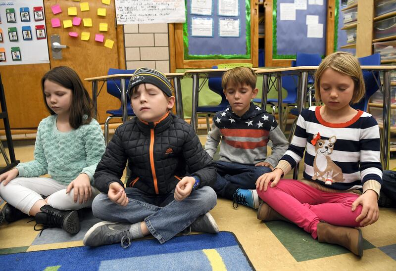 DENVER, CO - November 17: Merrill Middle School second graders from left to right, Piper Slavin, Peter Nichols, Carter Barker and Lila Gerlach close their eyes and collect their thoughts during a 15-minute Creative Challenge Community Mindfulness class at Merrill Middle School November 17, 2016. (Photo by Andy Cross/The Denver Post via Getty Images)