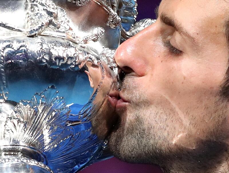 Novak Djokovic kisses his trophy. Reuters