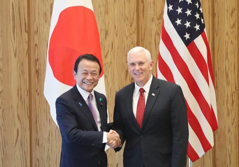 US vice president Mike Pence, right, and Japanese deputy prime minister and minister of finance Taro Aso shake hands during the Japan/US economic dialogue at the prime minister's office in Tokyo on April 18, 2017.  AFP