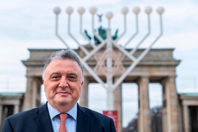 Israel's ambassador to Germany Jeremy Issacharoff poses in front of a giant Menora set up for the Jewish Hanukka Festival of Lights in front of Berlin's Brandenburg Gate, prior to an interview with AFP on December 17, 2020. A German court is to hand down its verdict Monday, December 21, 2020 on a deadly far-right attack in Halle last year that nearly became the country's worst anti-Semitic atrocity since World War II. Issacharoff called the attack "a very, very alarming moment in German history". / AFP / John MACDOUGALL / TO GO WITH AFP INTERVIEW by Fides MIDDENDORF and Deborah COLE
