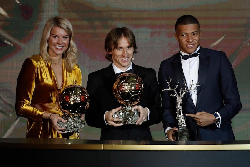Ada Hegerberg, Real Madrid's Luka Modric and Paris St Germain's Kylian Mbappe hold their 'Ballon d'Or' (Golden ball) trophies during the ceremony rewarding the best European footballer of the year in Paris. EPA