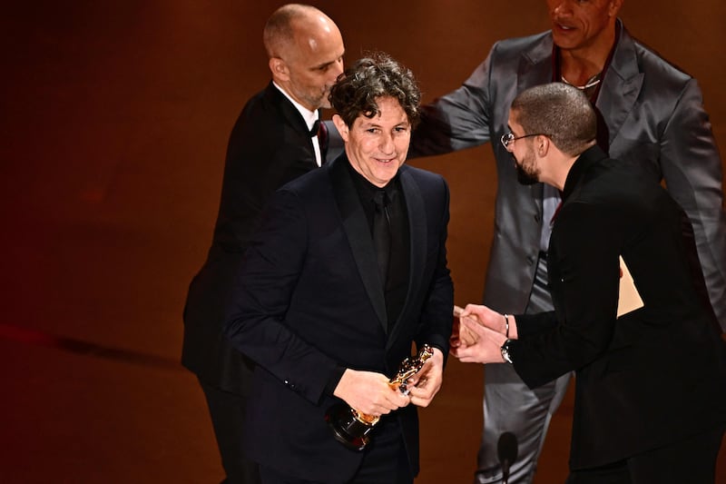 English director Jonathan Glazer accepts the award for Best International Feature Film for The Zone of Interest during the 96th Annual Academy Awards. AFP
