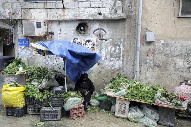 A Palestinian woman sells vegetables at the Burj al-Barajneh camp in the Lebanese capital Beirut on January 17, 2018. - The UN agency for Palestinian refugees warned it faced its worst funding crisis ever after the White House froze tens of millions of dollars in contributions, a move Palestinian leaders decried as cruel and blatantly biased. (Photo by JOSEPH EID / AFP)