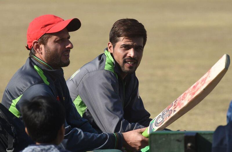 Shahid Afridi, left, alongside Mohammad Amir during a Pakistan training camp. Arif Ali / AFP